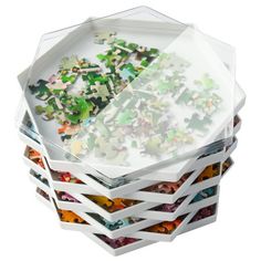 a stack of assorted pieces of glass sitting on top of each other in front of a white background