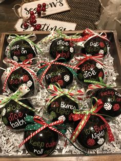 christmas baubles in a box with candy canes tied around the top and saying it's holiday