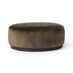 a round ottoman that is sitting on the floor