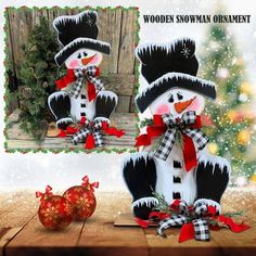 snowman ornament on wooden table with christmas decorations