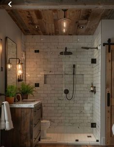 a bathroom with a shower, toilet and sink inside of it next to a wooden door