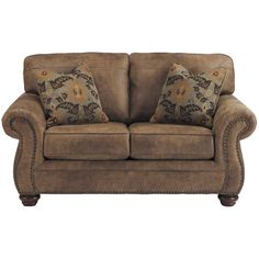 a brown couch with pillows on top of it