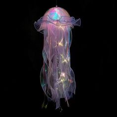 a purple jellyfish floating in the air with lights on it's back legs