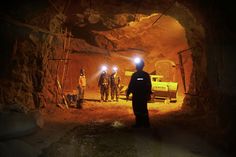 a group of men standing inside of a tunnel