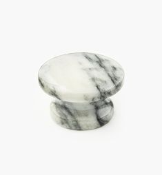 a white and black marble knob on a white background