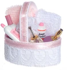 a pink and white basket filled with personal care items on top of a white surface