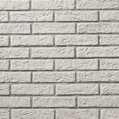 a white brick wall textured with cement