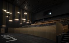 an empty auditorium with rows of seats and lights