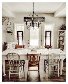 a dining room table with chairs and a chandelier