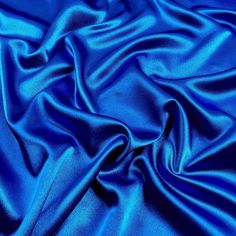 Royal Blue bridal satin fabric offers a beautiful smooth medium weight 100% polyester shiny satin material and popular for wedding dresses, gowns, apparel, fashion, and event decor. Bridal satin is an affordable option for table linens, draperies, chair covers, sashes, napkins, embroidered fabric, fashion, children's wear, crafts, and much more. Sold wholesale in a 70 yard roll. Color can vary by dye lot or batch. Bright Blue Color, Royal Blue Aesthetic Images, Blue Silk Background, Blue Silk Fabric, Silk Fabric Blue, Blue Satin Fabric, Blue Aesthetic Dark, Makeup Drawer Organization, Regency Dress