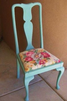 a blue chair with a flowered seat cover on it's back and side