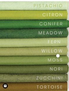 a stack of folded sheets with different colors and font on the bottom, including green