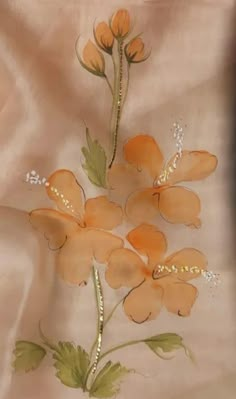 an image of flowers painted on the side of a bed sheet with beaded trim