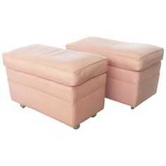 pair of pink leather ottomans with casteors