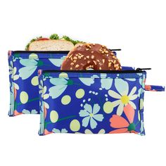 two blue floral lunch bags with donuts and sandwich in the middle one has an orange flower on it