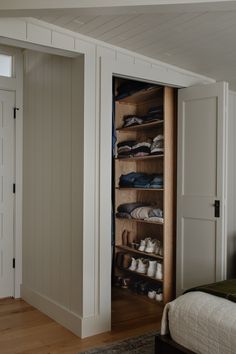 an open closet in the corner of a bedroom