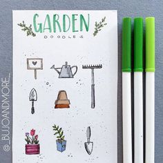 two green pens sitting next to an open notebook with gardening doodles written on it