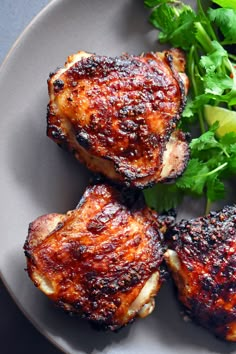 three pieces of meat on a plate with parsley