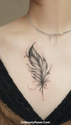 a woman's chest with a black and white feather tattoo on her left side