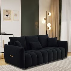 a black couch sitting on top of a wooden floor