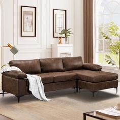 a living room with a brown couch and white rug