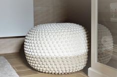 a white stool sitting on top of a tiled floor