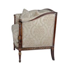 an old fashioned chair with white and brown upholstered fabric on the armrests