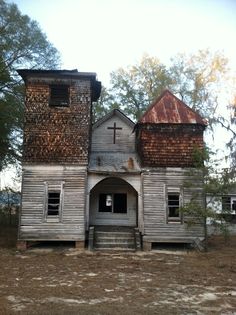 an old wooden church sitting in the middle of a forest