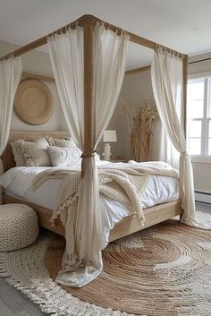 a large bed with white sheets and curtains on it's headboard in a bedroom