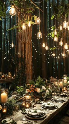 an outdoor dinner table with hanging lights and greenery