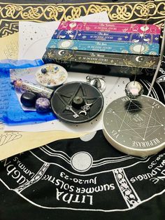 various items are laid out on top of a table with writing and symbols around them