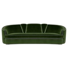 a green velvet sofa with white piping on the back and black trimmings