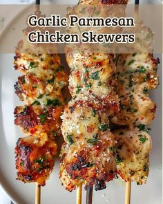 grilled chicken skewers with garlic parmesan sauce and herbs on them