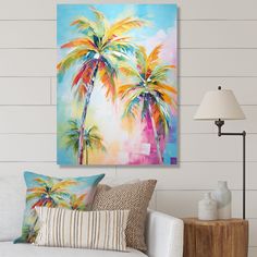 a living room with a couch, lamp and painting on the wall above it that has two palm trees