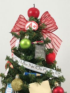 a christmas tree with ornaments and ribbons on it