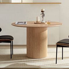 a round table with two chairs around it and a candle on the table next to it