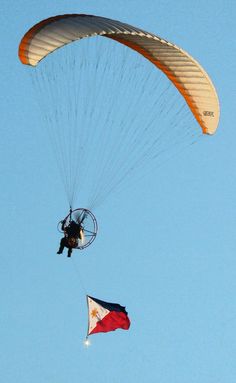 a person is parasailing in the air with a texas flag on it's tail