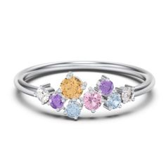 three stone ring in white gold with multi colored stones