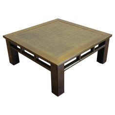 a square coffee table with an intricate design on the top