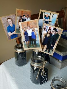 mason jars with pictures on them sitting on a table