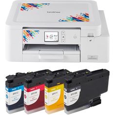 four different color ink cartridges in front of a printer