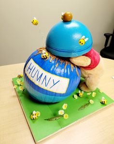 a stuffed animal sitting on top of a blue ball with the word hummy written on it