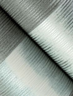 a close up view of the fabric in grey and white stripes on a piece of cloth