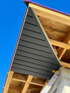 a house being built with wooden framing and blue sky in the backgrouds