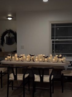 a long table with many lit candles on it