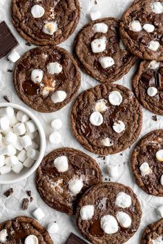 several chocolate cookies with marshmallows on top