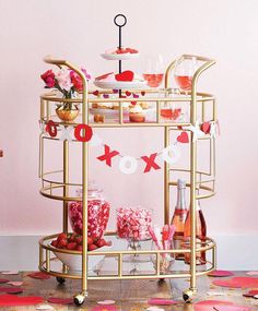 a gold serving cart filled with desserts and drinks