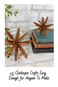 a snowflake made out of wood sticks sitting on top of a stack of books