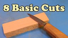 a wooden block with a knife on top of it and the words 8 basic cuts