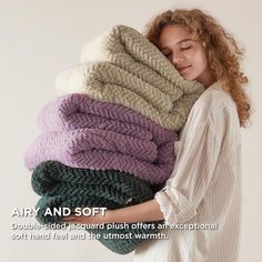 a woman holding a pile of blankets in her arms with the caption airy and soft